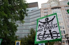 Sign outside World Bank that reads "People Over Profits"