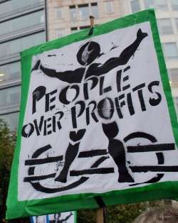 Sign outside World Bank that reads "People Over Profits"