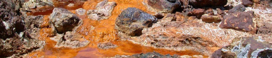 acid drains from the Rio Tinto River, turning the water a bright copper color