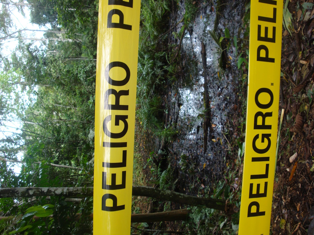Caution tape encircles a crude oil contaminated area near Lago Agrio, Ecuador