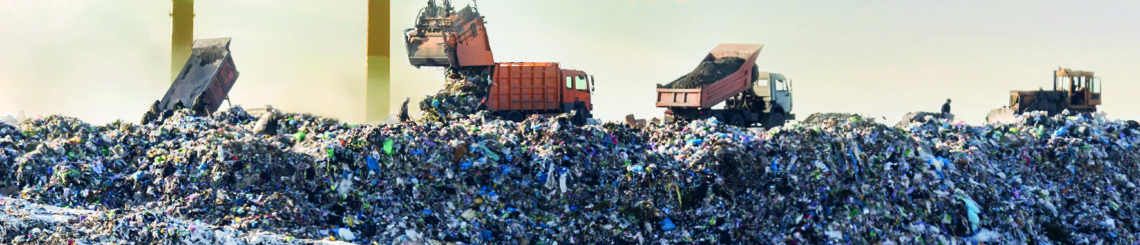 Dump trucks unloading garbage over vast landfill. Smoking industrial stacks on background. Environmental pollution. Outdated method of waste disposal. Survival of times past. Plastic & Climate: The Hidden Costs of a Plastic Planet.