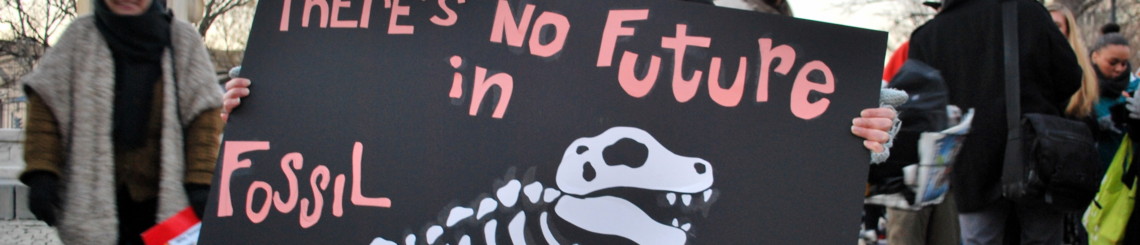 Protester holding "There's no future in fossil fuels" sign during divestment day
