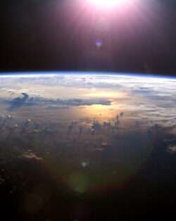 a view of earth from space and the sun