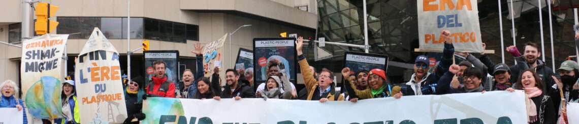 People holding a sign that reads End Plastic Era